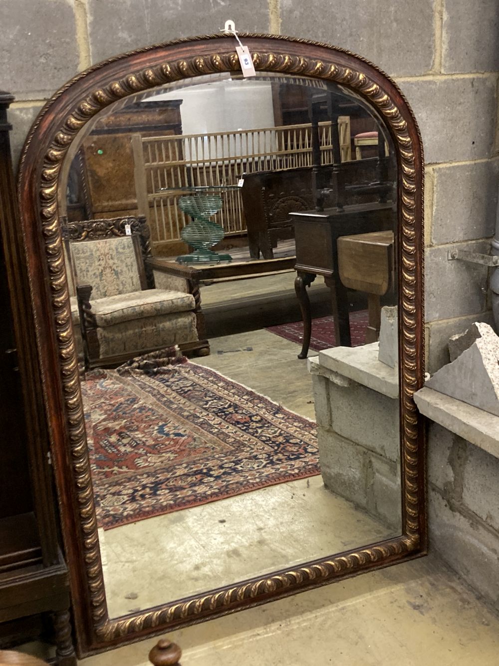 A Victorian style arched overmantel mirror, width 106cm height 150cm.